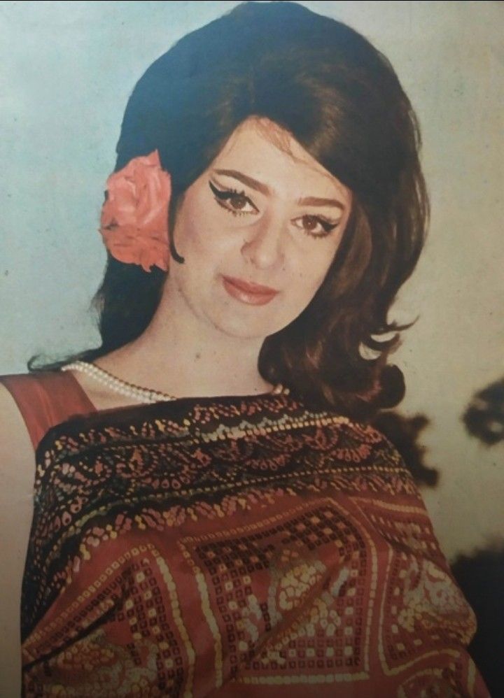 an old photo of a woman with a flower in her hair