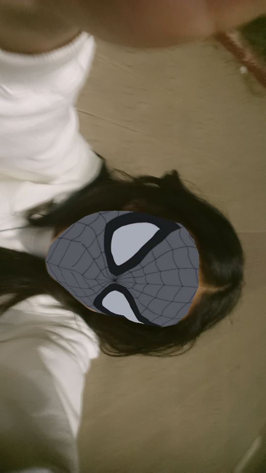 a woman with her hair in the shape of a spider - man mask is seen from above