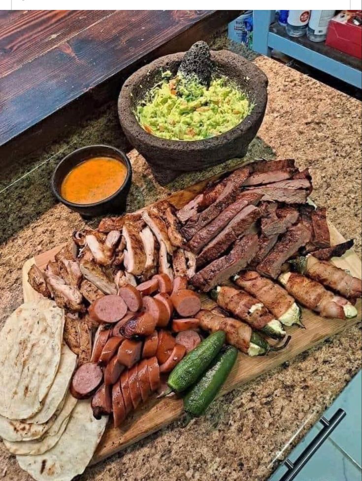 a wooden cutting board topped with meat and veggies