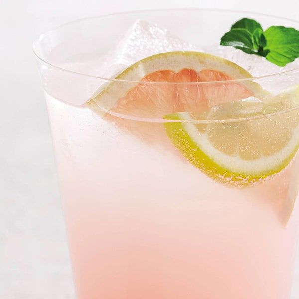 a pink drink with lemon and mint garnish