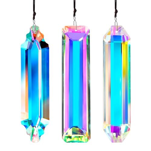 three different colored crystals hanging from strings