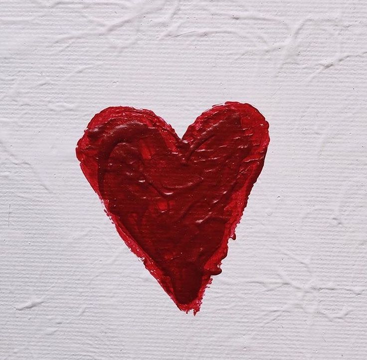 a red heart painted on white paper