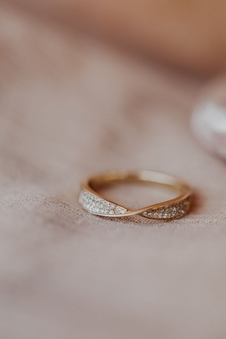 a close up of a gold ring with diamonds on the inside and in the outside