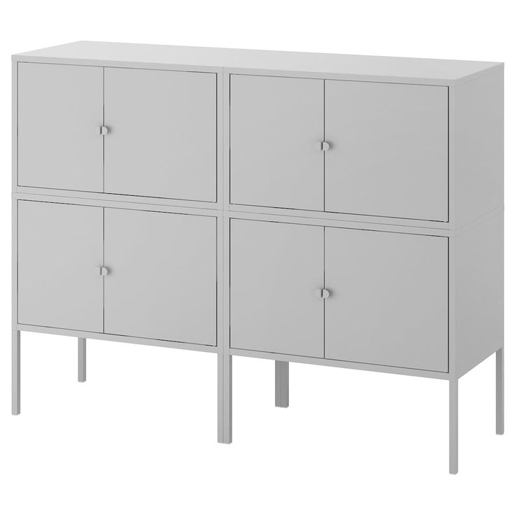 a white cabinet with four doors and two legs on the bottom, in front of a white background