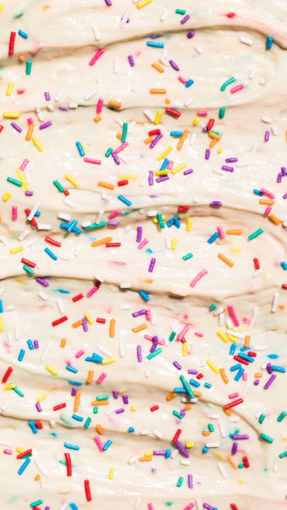 an ice cream sundae with sprinkles and white frosting