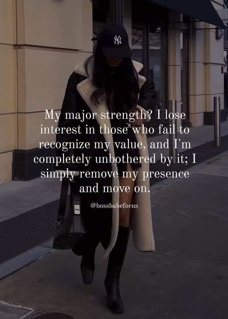 a woman walking down the street with a coat over her head