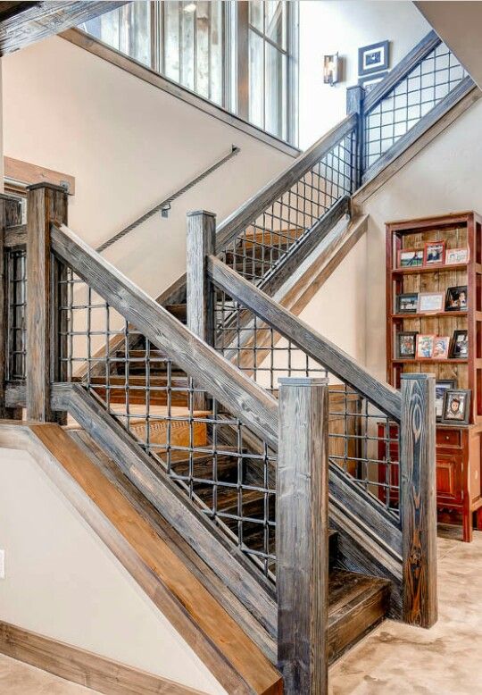 a wooden staircase with metal handrails in a home