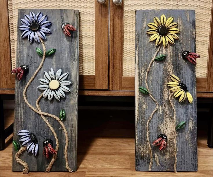 two wooden boards decorated with flowers and ladybugs are sitting on the floor next to each other