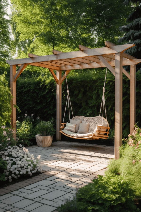 a swing chair in the middle of a garden