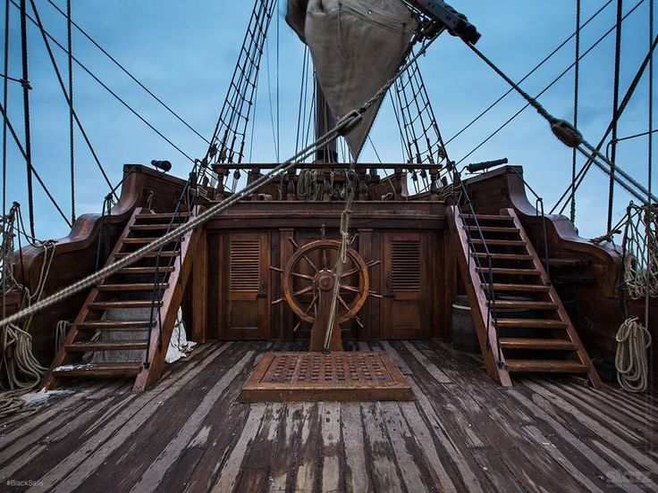 an old wooden ship deck with stairs leading up to it