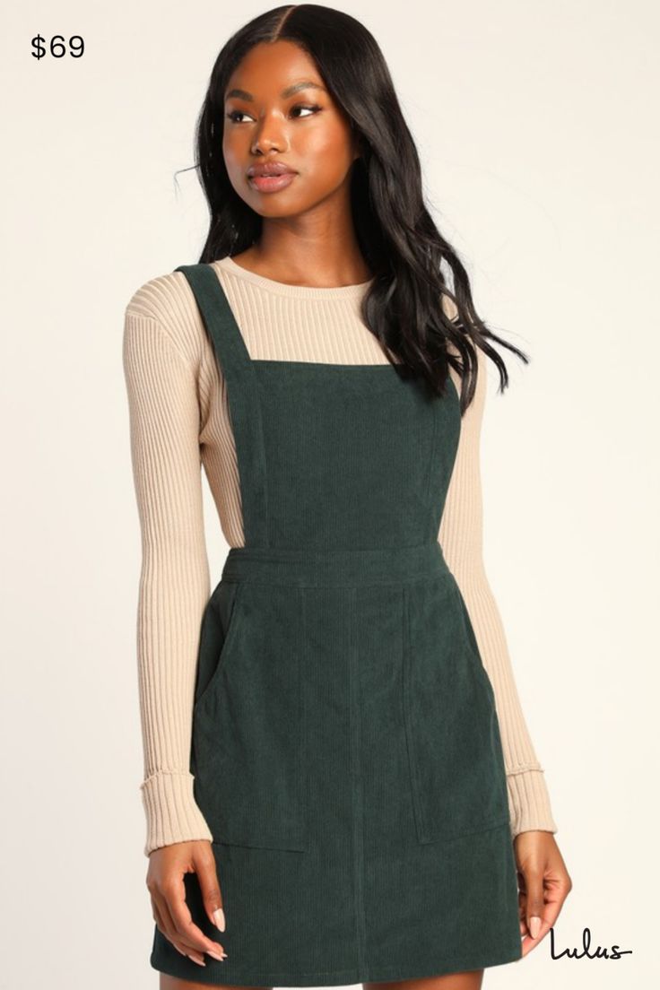 The Lulus Embracing Autumn Emerald Green Corduroy Pinafore Mini Dress is the overall winner for the cutest look this season! This trendy pinafore dress has a velvety corduroy composition that shapes an apron-style bodice, a square neckline, and wide straps. A banded waist tops a figure-skimming mini skirt with front patch pockets. Exposed silver back zipper. Layer with a mock neck top for a retro 'fit! Fit: This garment fits true to size. Length: Mid-thigh. Size medium measures 33.25" from shoulder to hem. Bust: Great for any cup size. Waist: Fitted - very fitted at natural waist. Hip: Loosely Fitted. Fabric: Fabric has no stretch. Unlined. 97% Polyester, 3% Spandex. Hand Wash Cold. Do Not Bleach. Line Dry. Iron Low Heat. Imported. Lulus | Embracing Autumn Emerald Green Corduroy Pinafore M Emerald Green Outfit, Corduroy Pinafore, Corduroy Pinafore Dress, Lulu Fashion, Green Corduroy, Corduroy Dress, Mock Neck Top, Green Outfit, Pinafore Dress