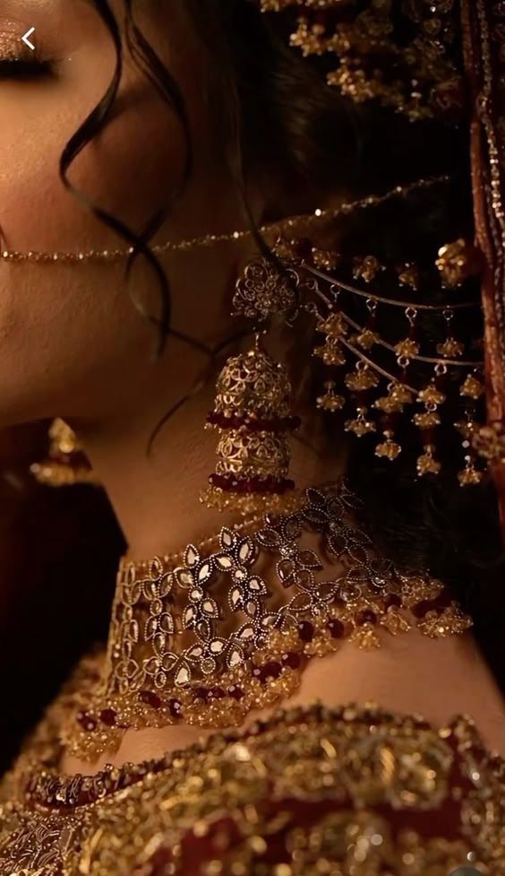 a close up of a woman in a bridal dress with jewelry on her neck