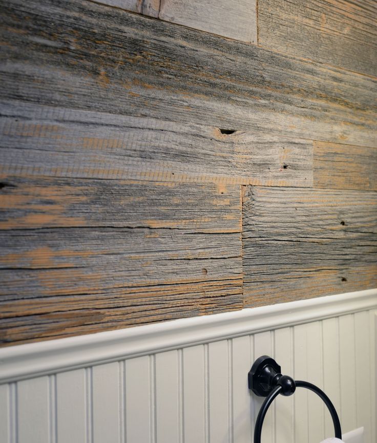 a bathroom wall with wood planks on it