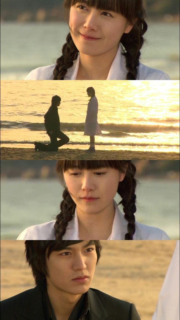 two people standing on top of a beach next to the ocean and one person with long hair