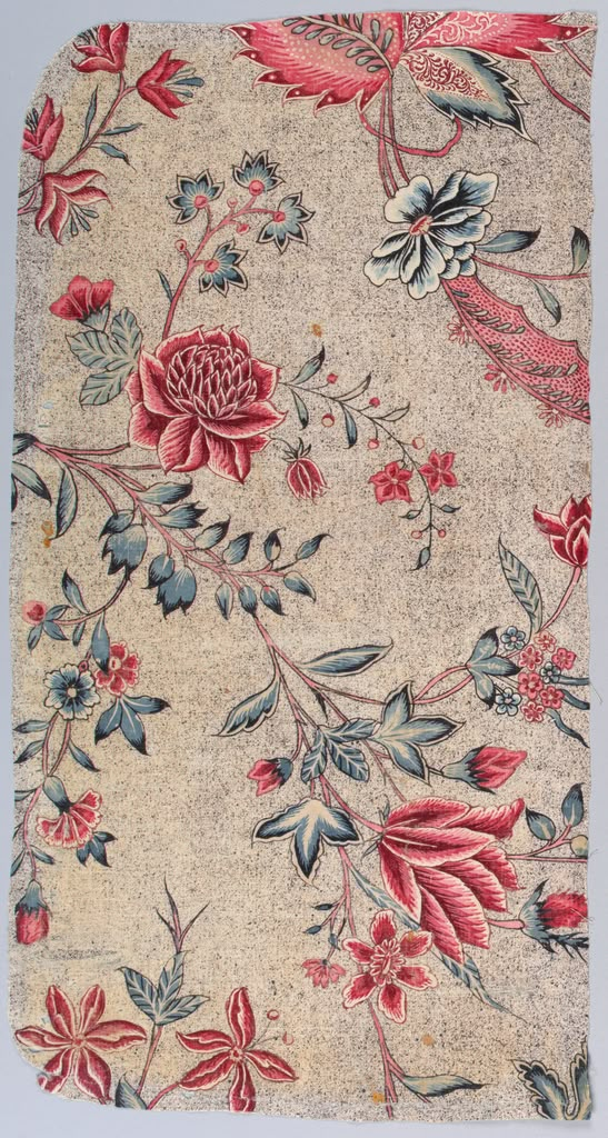 an old rug with flowers and leaves on it