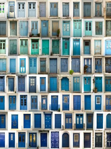 many windows with blue doors are stacked together