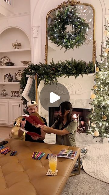 a woman holding a baby in her arms while sitting on a couch next to a christmas tree