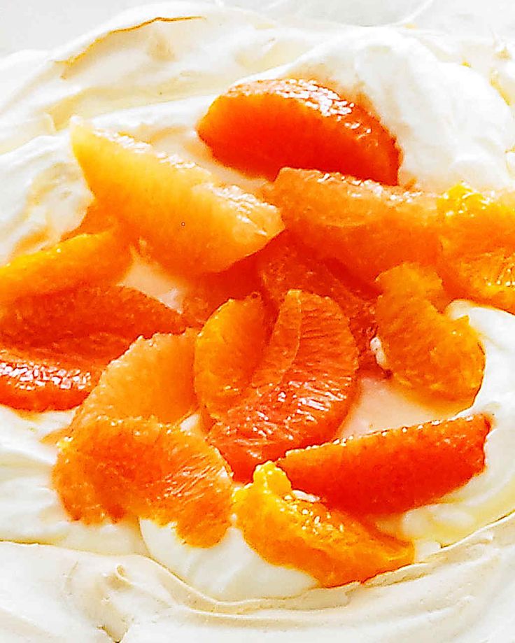 a white plate topped with oranges and whipped cream