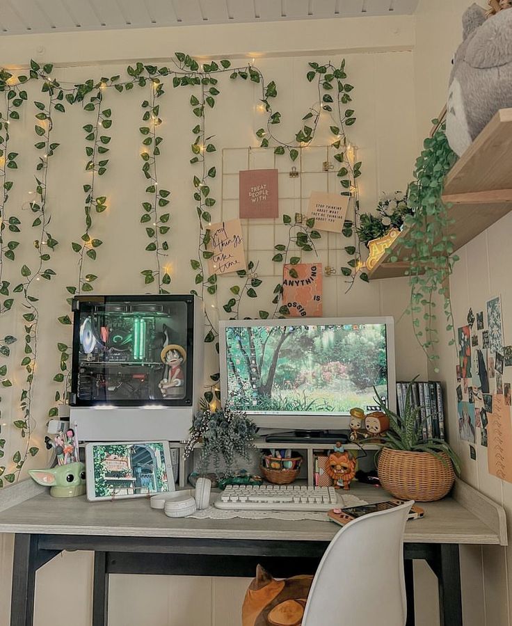 a desk with a computer, keyboard and monitor covered in ivy on the wall behind it