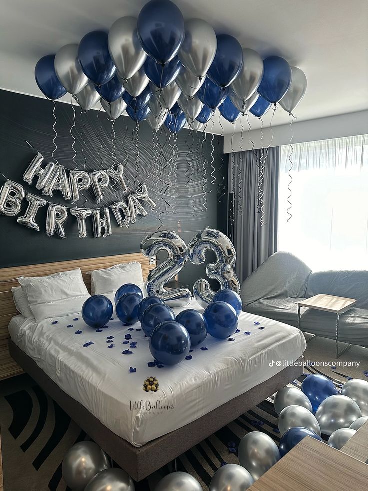 a bedroom decorated in blue and silver balloons