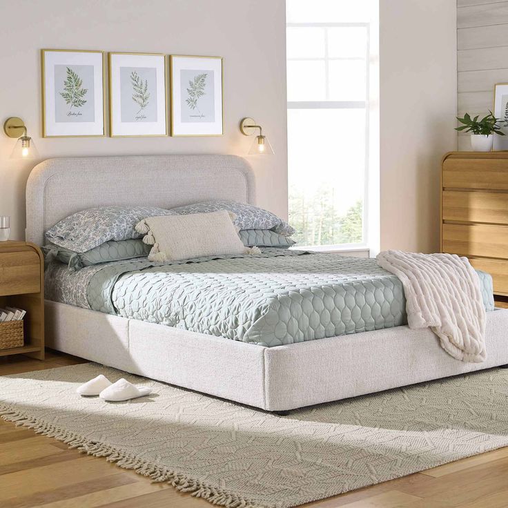 a white bed sitting on top of a wooden floor