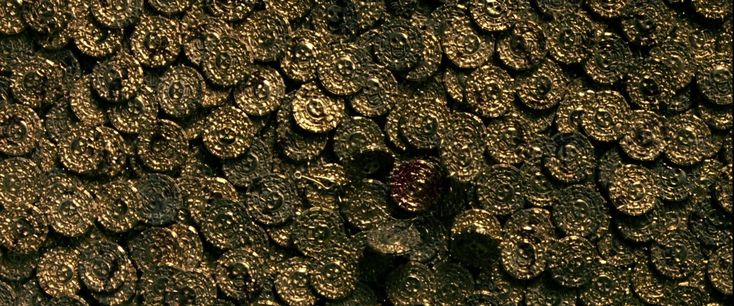 a close up view of the surface of a black and gold fabric with circles on it