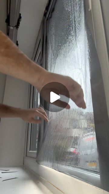 a person reaching for something on the window sill