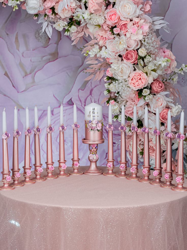 there is a cake with candles and flowers on it