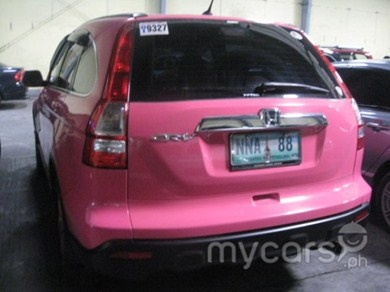 the back end of a pink honda cr - v parked in a parking garage with other cars