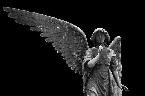 an angel statue is shown in black and white