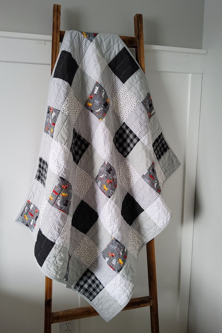 a quilt hanging on a ladder in a room