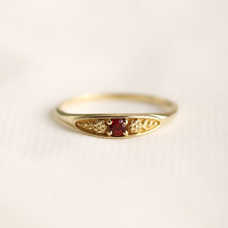 January birth ring This ring will be a very meaningful piece for those born in January. January's birthstone and birth flower are garnet and carnation. Brilliant red garnet and delicately carved carnations will shine and bloom forever. This dainty and slim signet ring is comfortable to wear all the time. This piece will be perfect gift for both to others and yourself. * Detail * Material : 14K solid gold, 18K solid gold, 925 sterling silver Color : Yellow gold, White gold or Rose gold(925 sterling silver is excluded) Stone : Natural Garnet(2.5mm) * Size * Top width : 3.7mm Shank width : 1.2mm Band depth : 2.4-0.9mm * Please check your ring size before ordering, Use this : http://www.onlineconversion.com/ring_size.htm We provide special package with some our business card, guarantee card, g Affordable Minimalist Gemstone Rings, Danty Garnet Rings, Small Vintage Ring Cheap, Dainty Art Deco Ring, Simple Gold Rings Everyday Vintage, Affordable Vintage Rings As Gifts, Garnet Starburst Ring, Birth Stones Wedding Rings, Vintage Simple Gold Ring