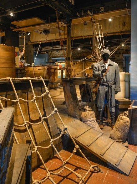 an old pirate ship is on display in a museum with ropes and other items around it