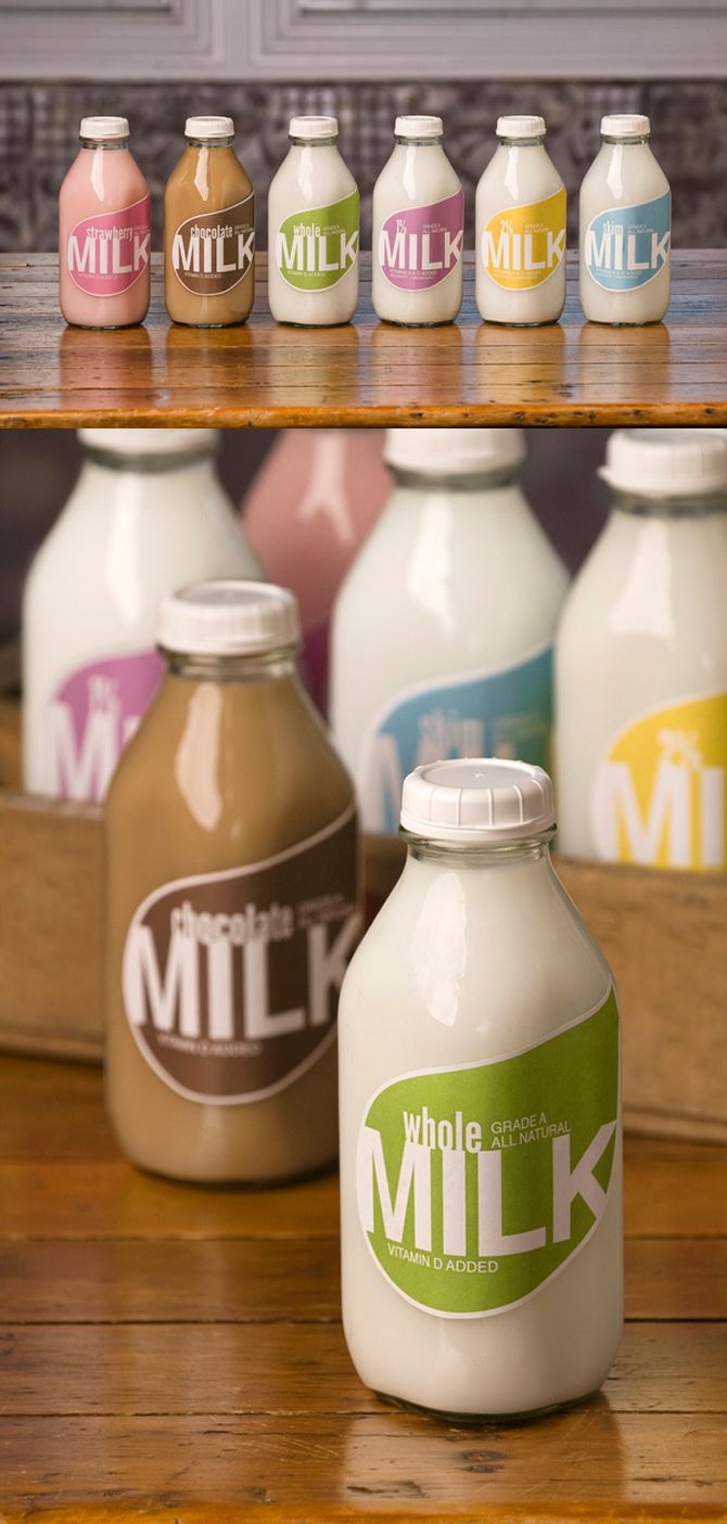 several milk bottles sitting on top of a wooden table