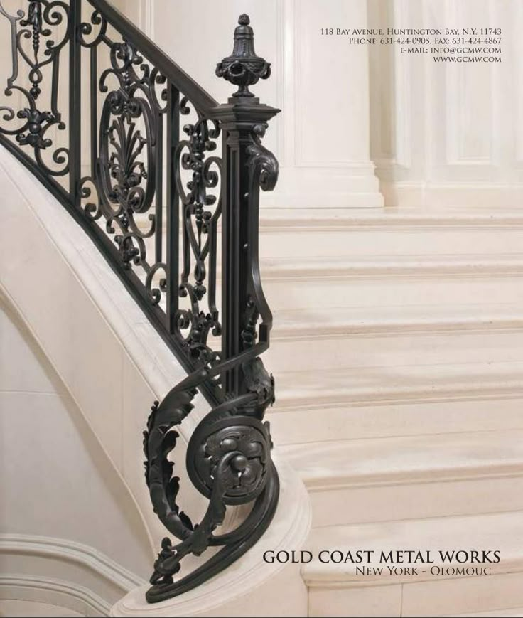 an ornate iron stair railing and handrail in a white room with marble flooring