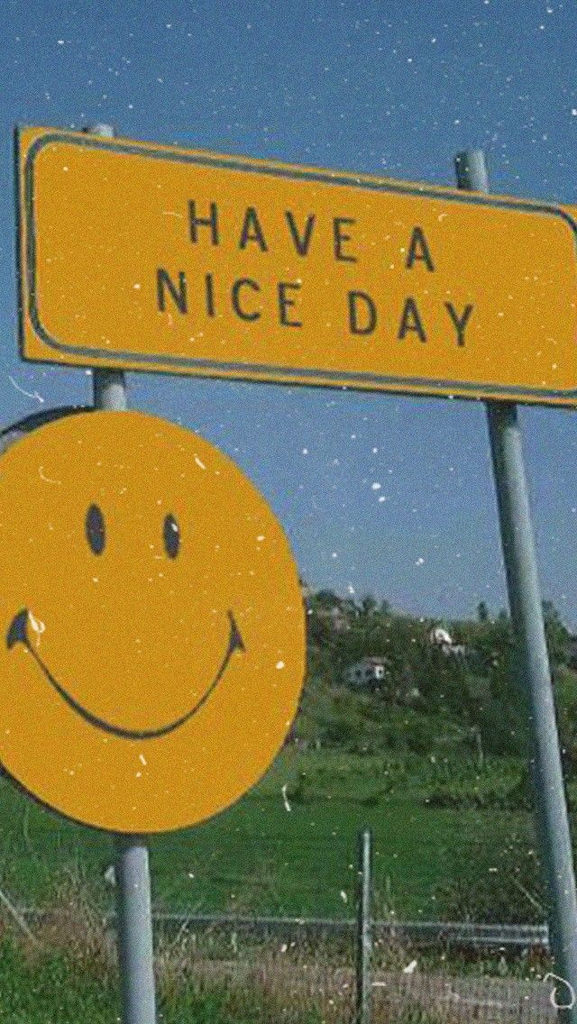 two yellow street signs that say have a nice day