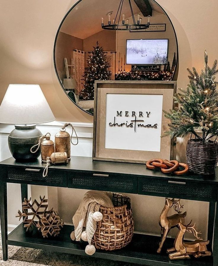 a table with christmas decorations on it and a mirror