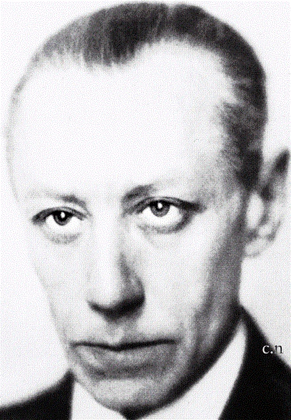 an old black and white photo of a man in a tuxedo looking at the camera