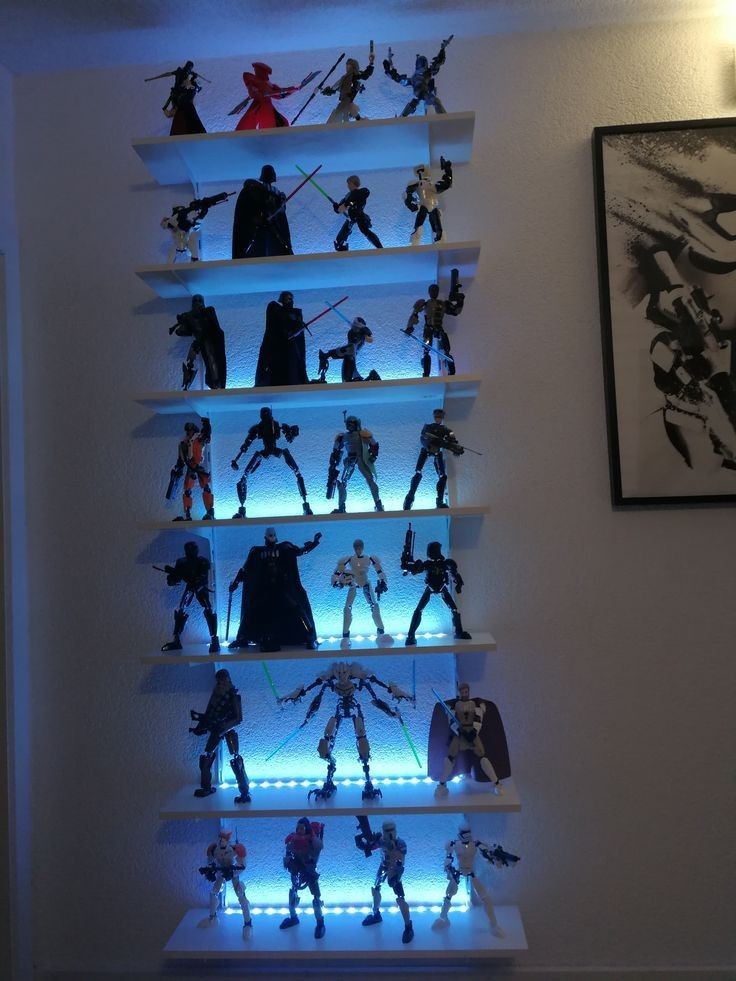 a collection of star wars action figures is displayed on a shelf in the corner of a room