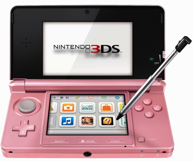 a pink nintendo 3ds game system with a pen sticking out of the top cover