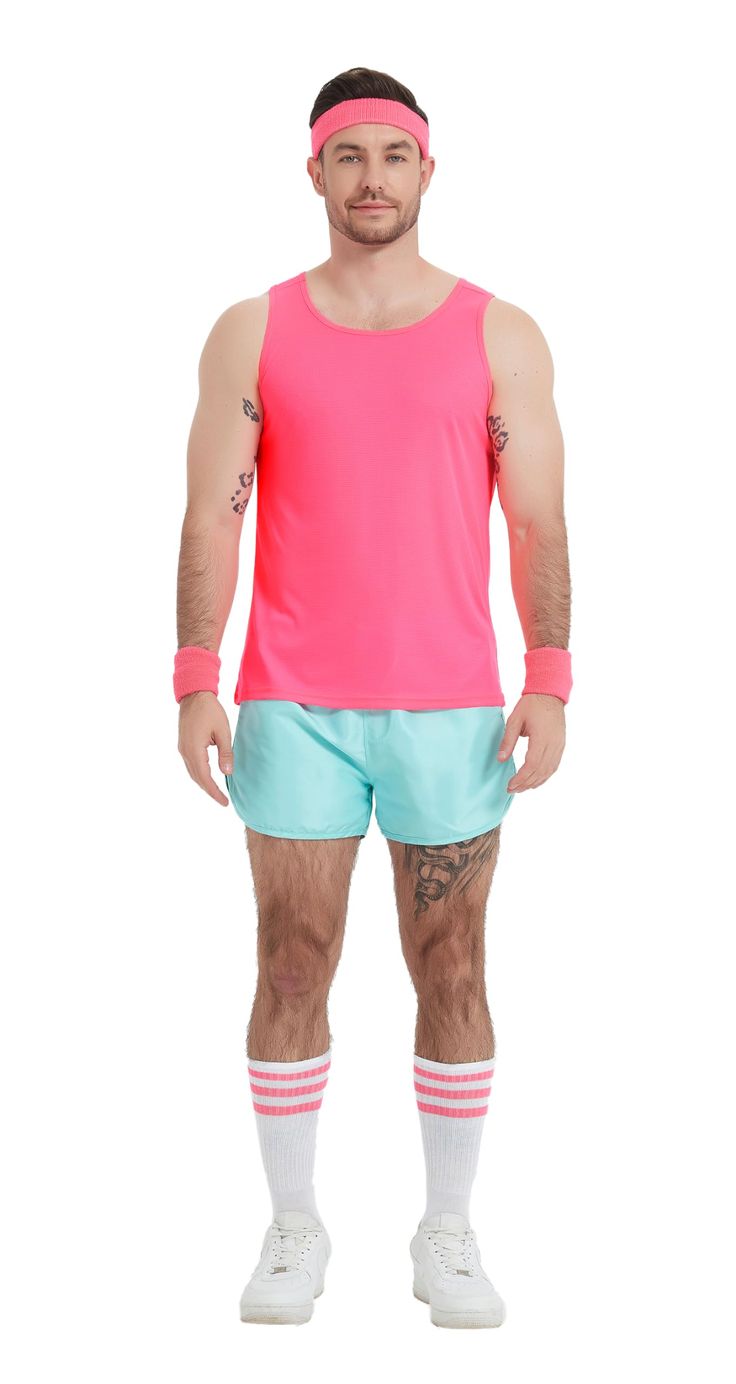 a man in pink shirt and blue shorts standing with his hands on his hipss