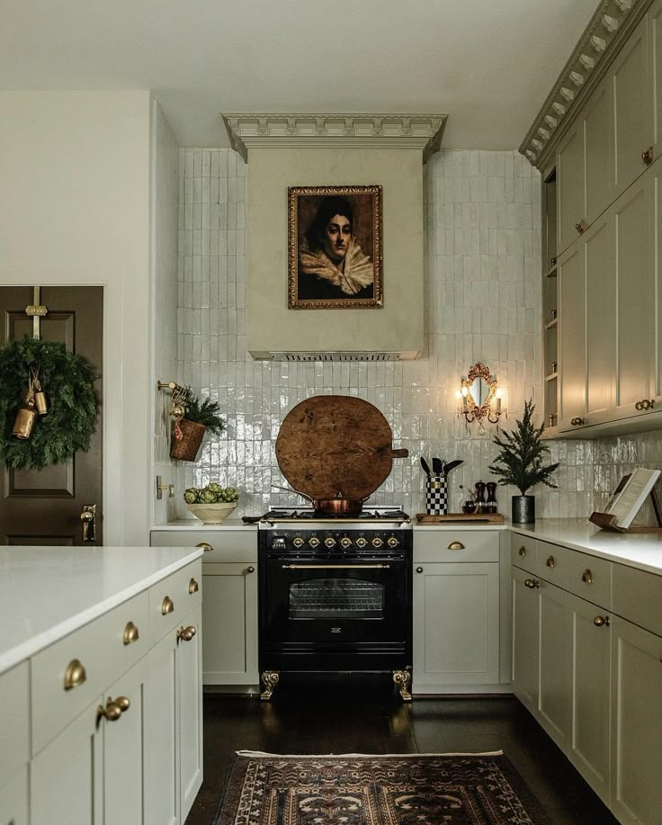 a kitchen with white cabinets and an old fashioned stove in the center, surrounded by potted plants