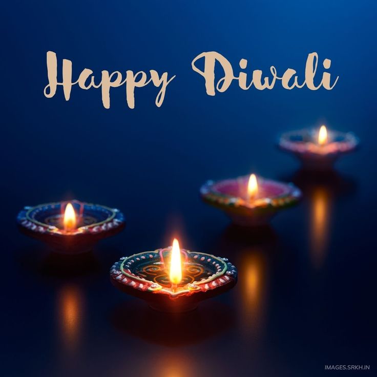 happy diwali with lit candles on dark blue background for diwali festival