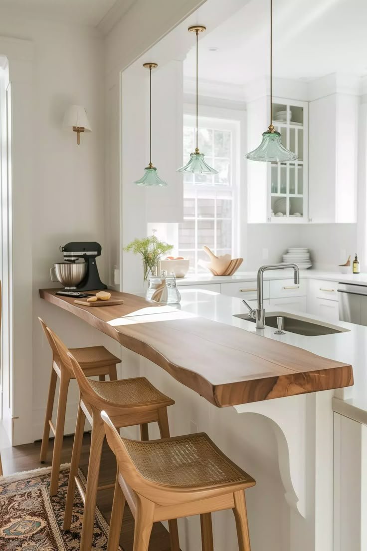 a kitchen with white walls and wooden stools