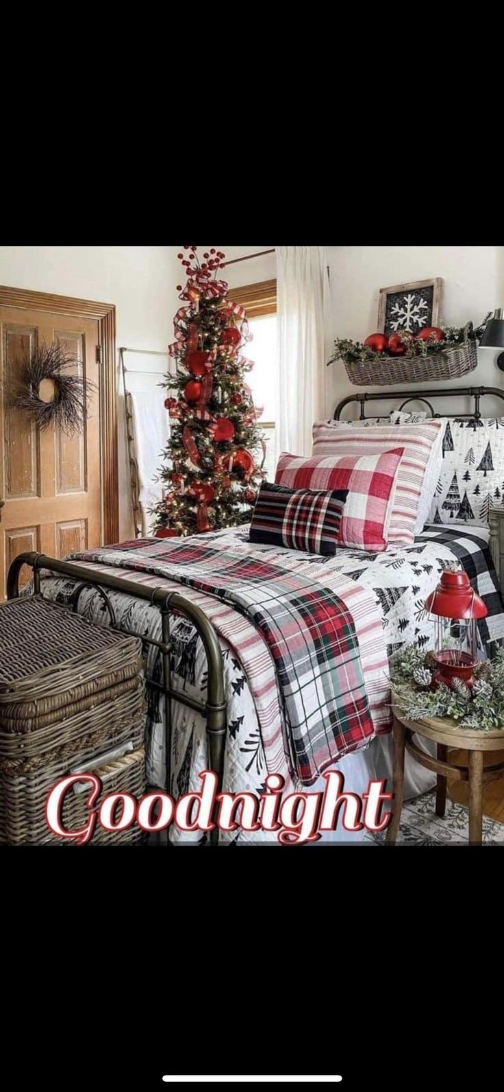 a bed room with a neatly made bed and a christmas tree