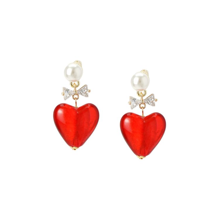 A pretty yet striking earring featuring a vibrant red lampwork glass heart and a sparkly bow dangling from a pearl stud for an eye-catching tonal effect. They style beautifully as a solo pair, or layered with smaller studs and hoops. Handmade  Material: cz crystal, lampwork glass, faux pearl, sterling silver posts Elegant Party Earrings With Heart Beads, Red Double Heart Earrings For Party, Elegant Heart Bead Earrings For Party, Elegant Party Heart Earrings With Beads, Red Heart Charm Earrings For Party, Elegant Red Heart Charm Earrings, Elegant Red Earrings With Heart Charm, Elegant Red Heart Earrings For Gift, Elegant Red Double Heart Earrings