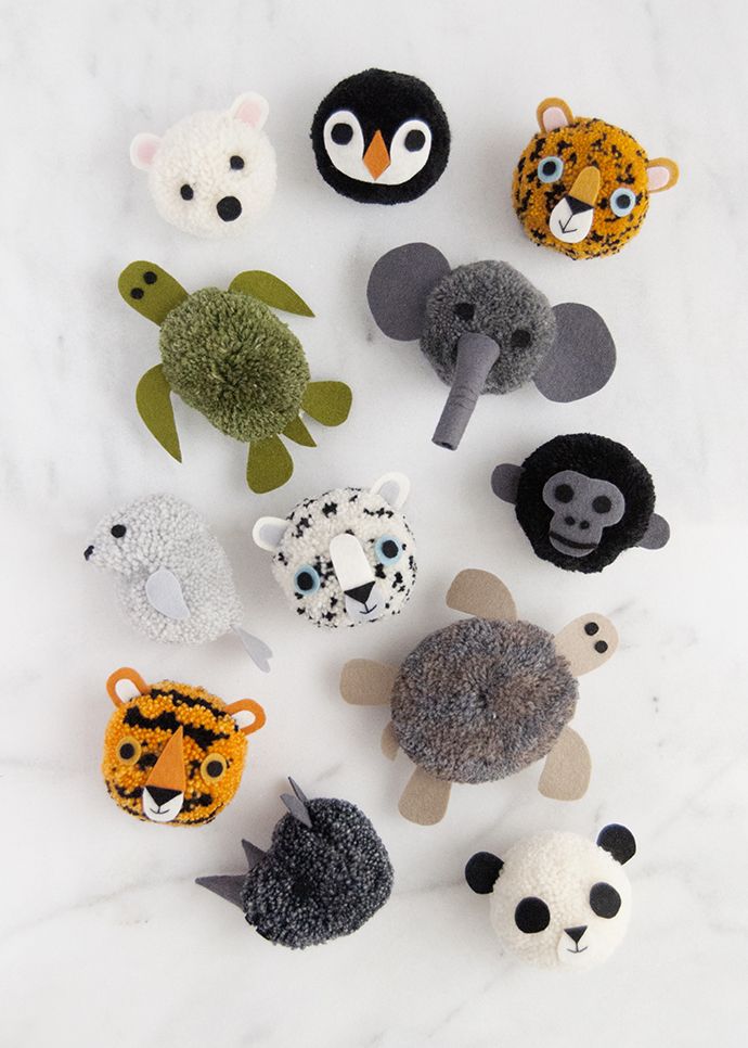 an assortment of stuffed animals on a white surface with black and orange ones in the middle