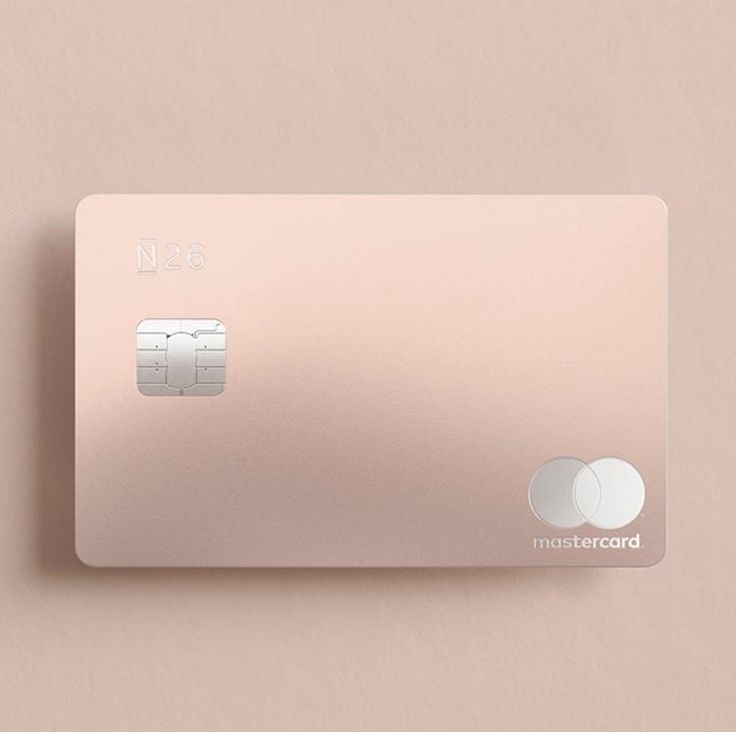 a pink credit card sitting on top of a table