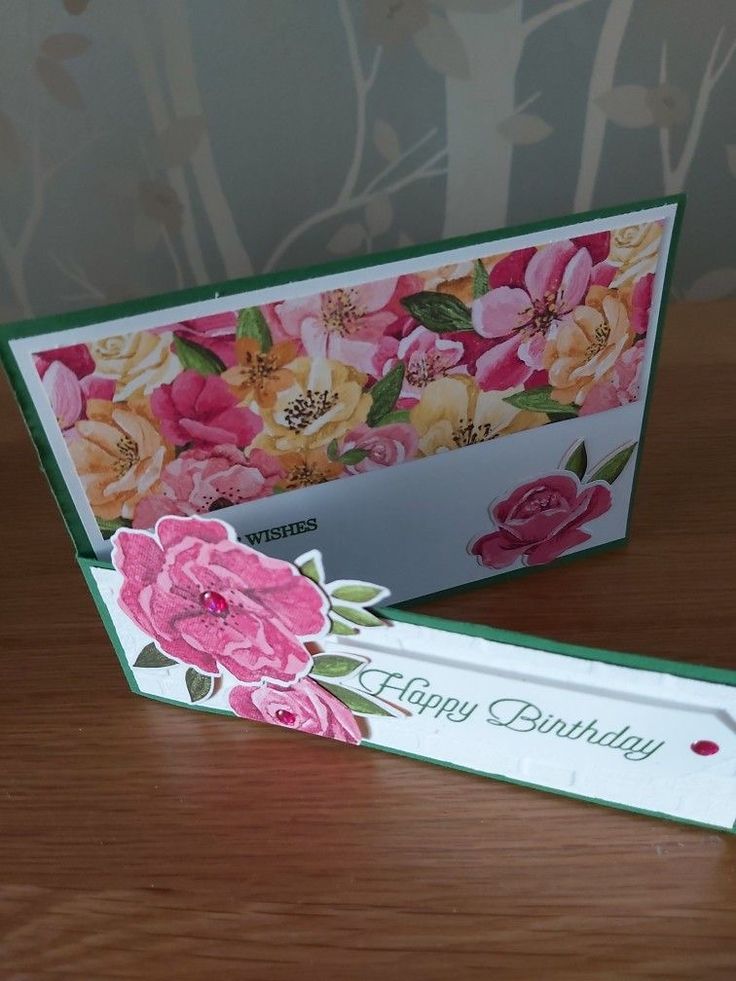 an empty birthday card sitting on top of a table next to a flowered envelope