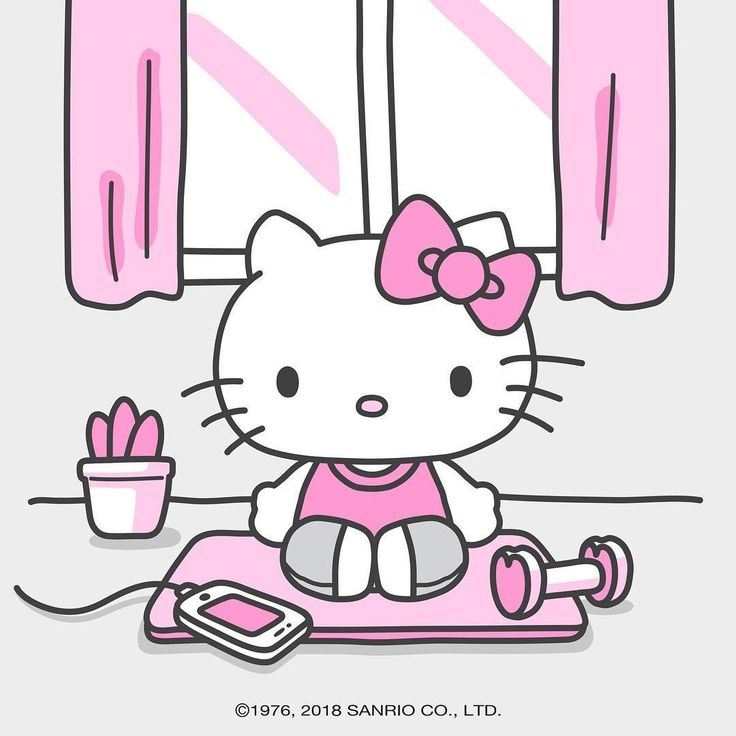 a hello kitty sitting on top of a pink mat